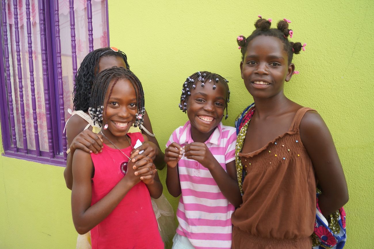 Friends outside pharmacy in Huambo