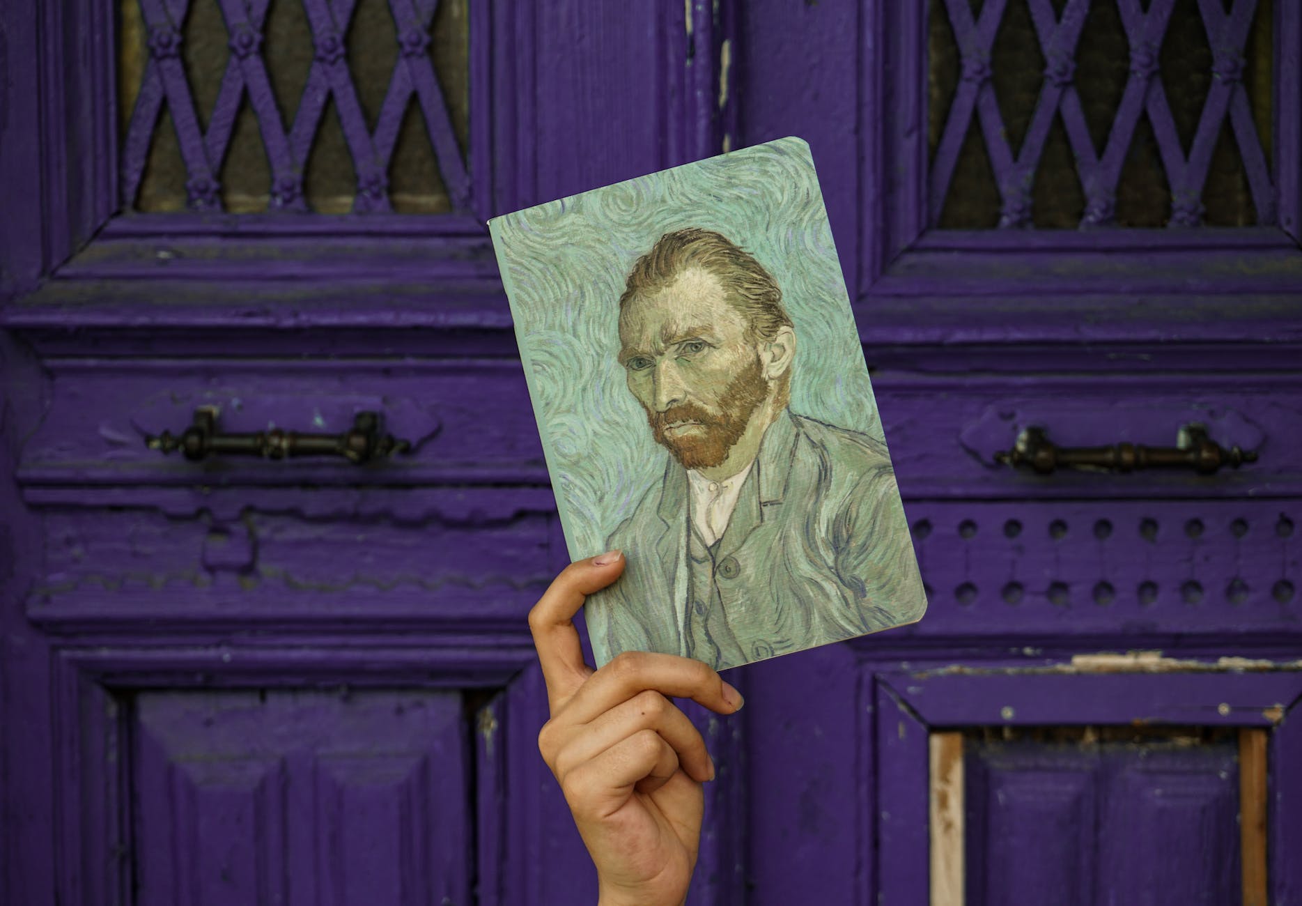 a person holding a van gogh self portrait